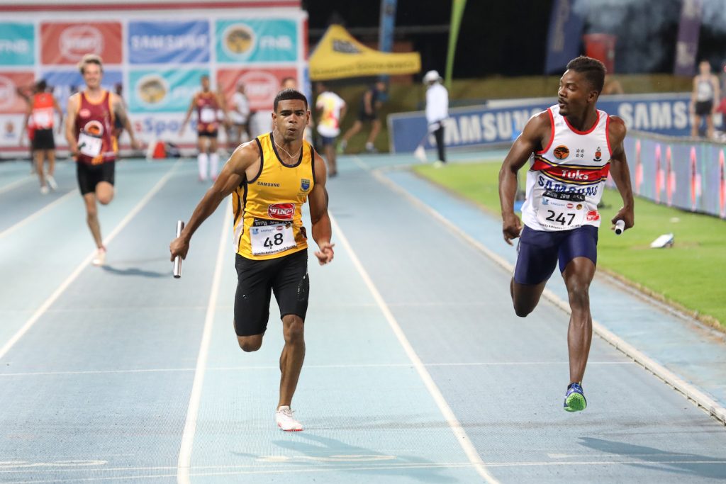 Thembo Monareng of Tuks and Tyler Linnen of UWC during the Men's 100m Relay, At Tuks Athletics, Friday 2 March 2018